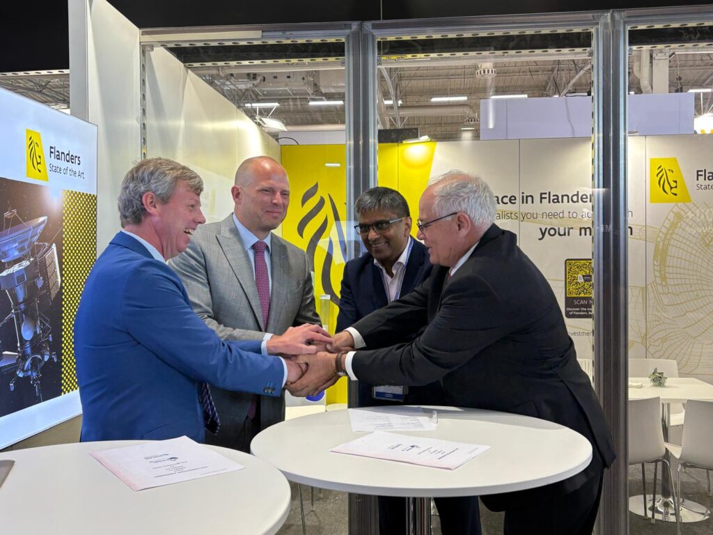 Bill Minkoff and Bert Buyle shaking hands with new business partners at a Flander event