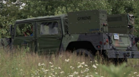Gyrene being used in a military setting on the back of a military pickup truck to supply soldiers with water 